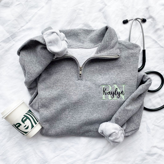 quarter zip sweatshirt with collar, medical credentials and name layered and embroidered on the left chest.