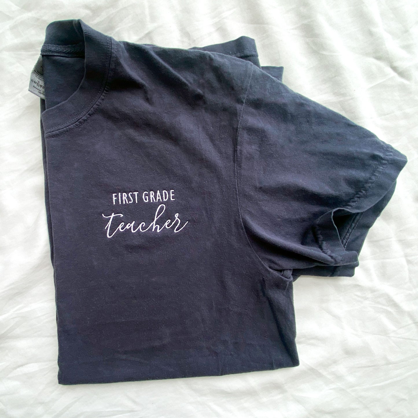 navy comfort colors tshirt with personalized grade level and teacher embroidered design in white thread
