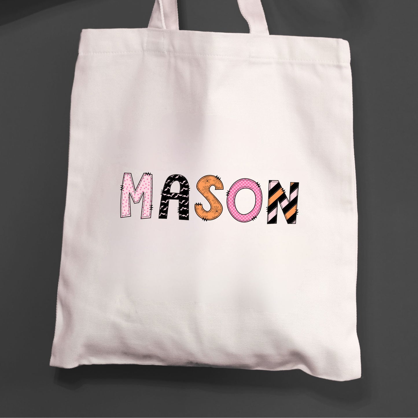 Natural tote bag for trick or treating with a printed custom name design in a mixed pattern font