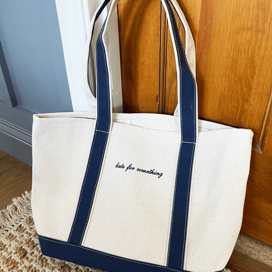 navy trim canvas tote bag with custom mini script embroidery in navy thread