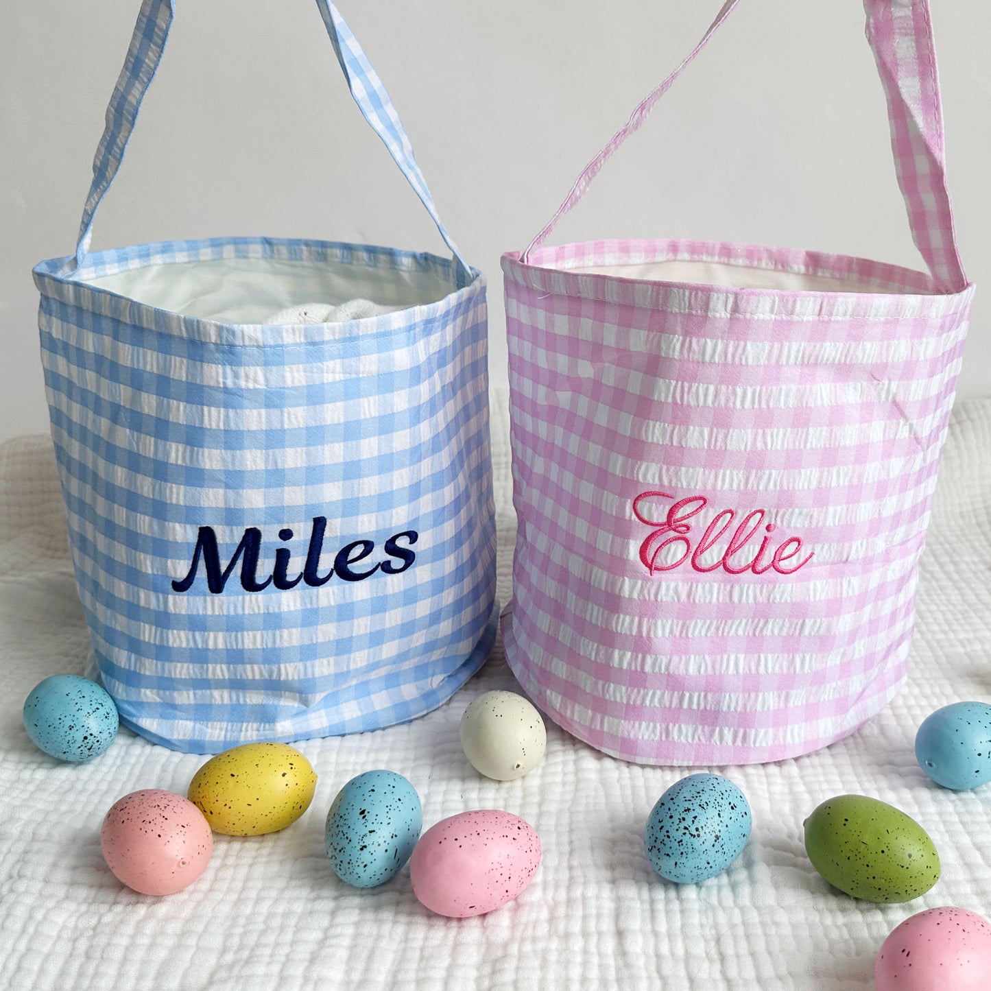 two easter baskets with custom name embroidery across the center