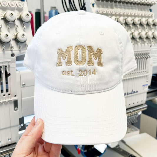 white hat with custom varsity mom and date embroidered design
