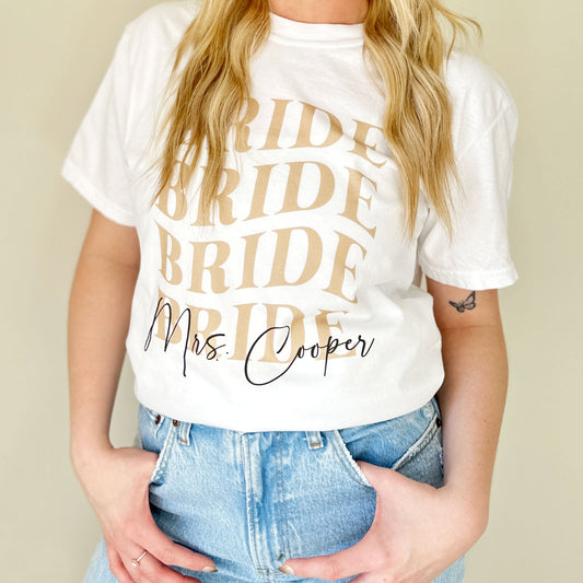 close up image of a woman wearing a custom comfort colors bride t-shirt with personalized name print