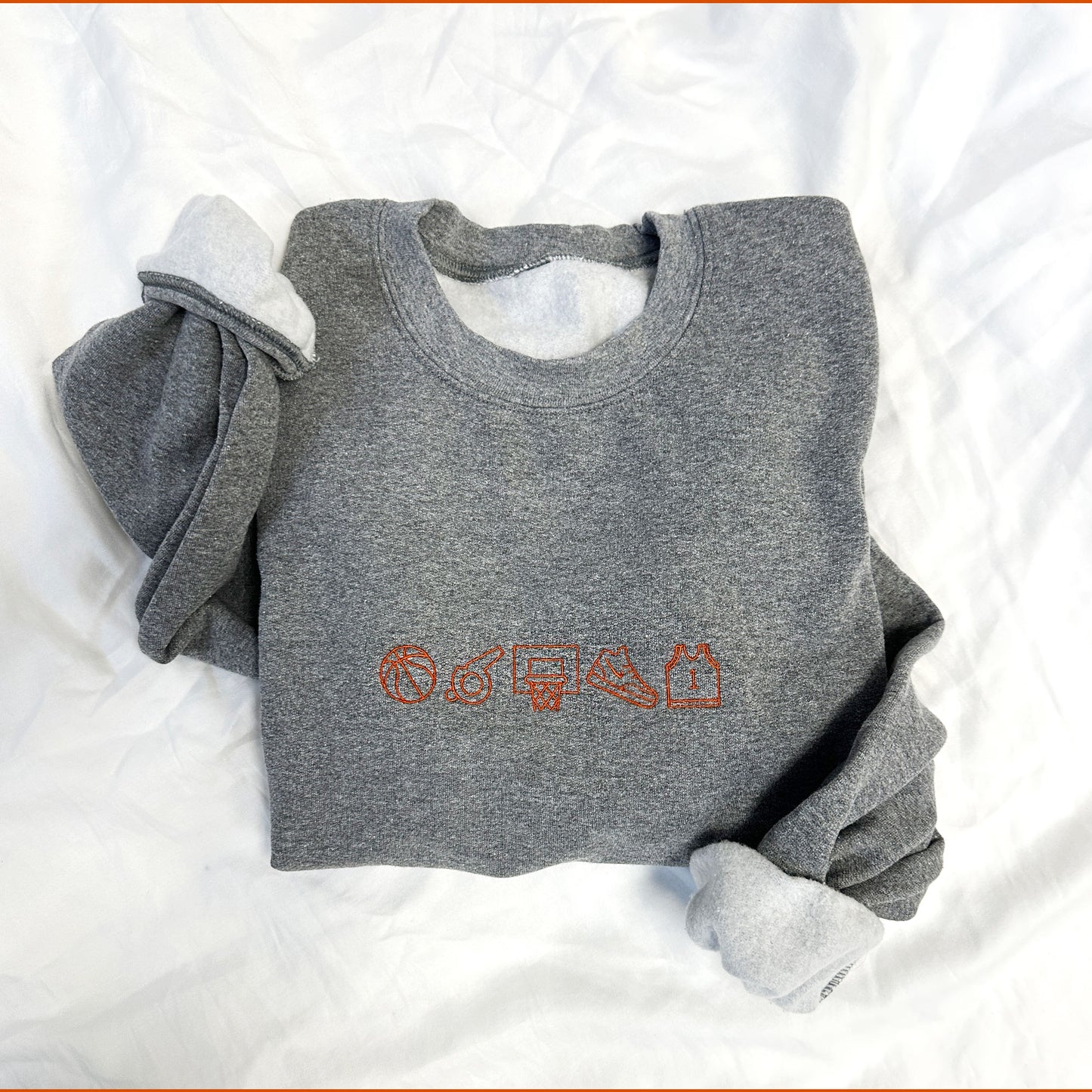 embroidered basketball icon top on a graphite heather crewneck sweatshirt