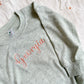 close up of a personalized name embroider on a baby romper