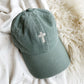 Sawgrass Green Baseball hat with mini cross embroidered in the center in natural thread