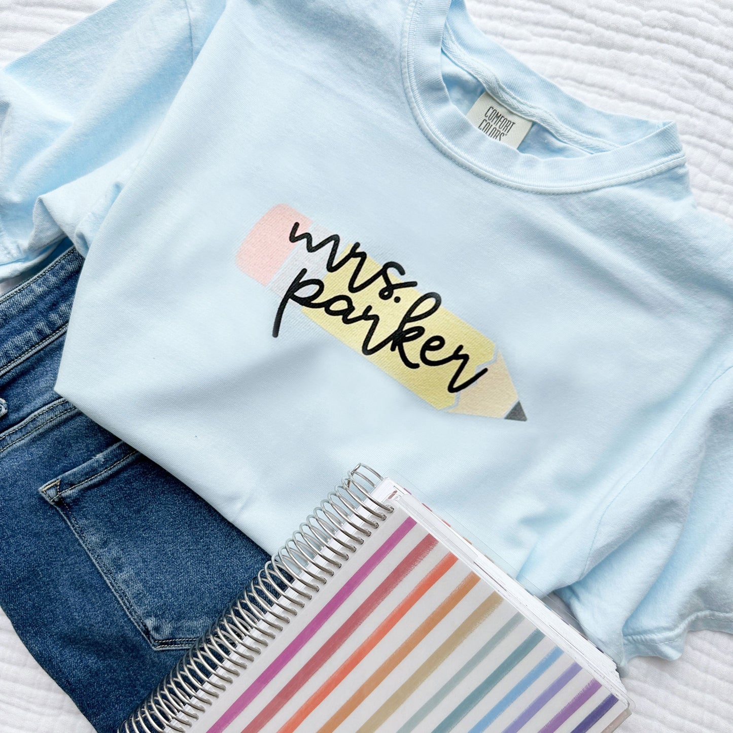 chambray blue comfort colors t-shirt with cute large pencil printed design on the center chest