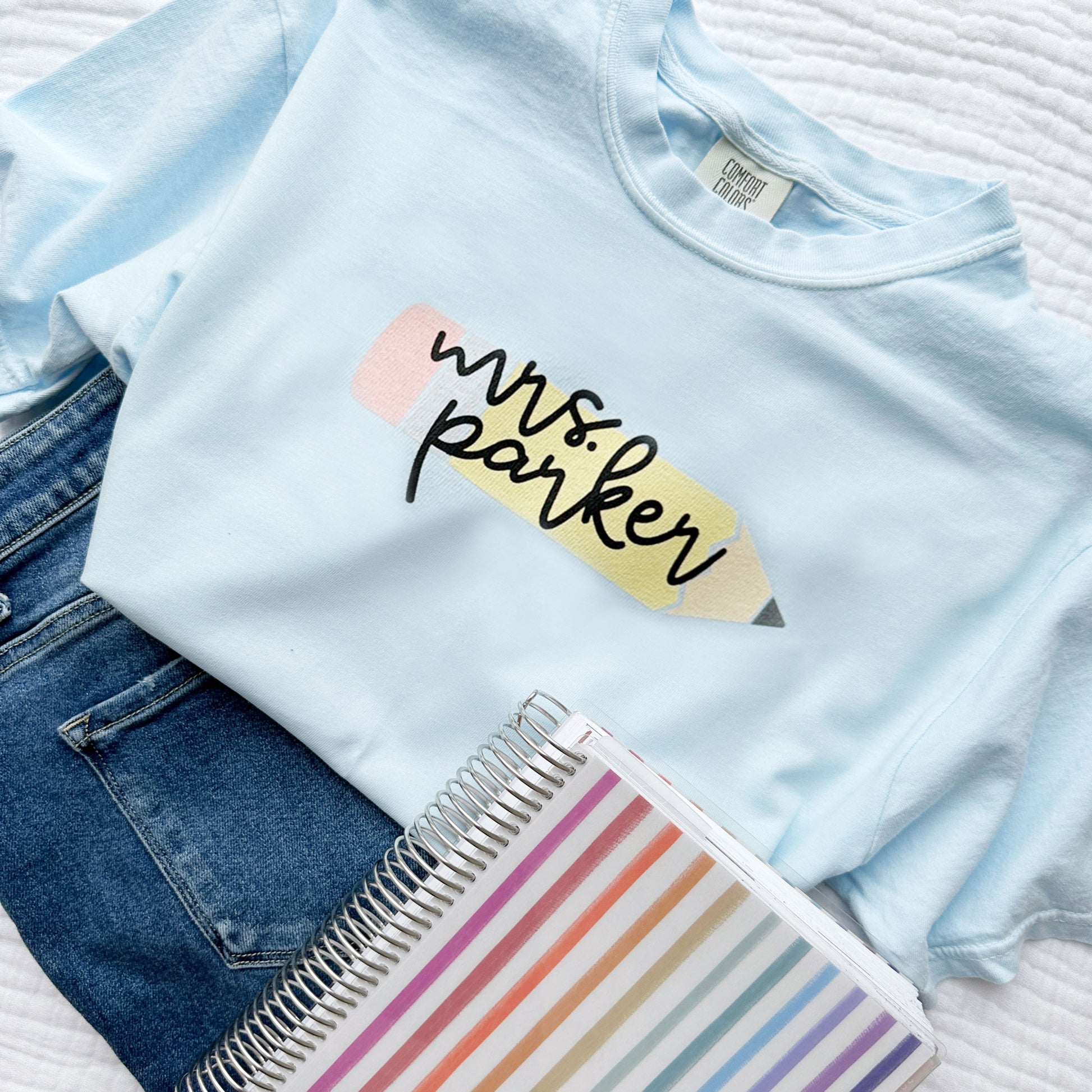 chambray blue comfort colors t-shirt with cute large pencil printed design on the center chest