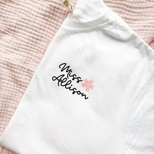 comfort colors t-shirt with a cute custom name and mini flower design on the front left chest