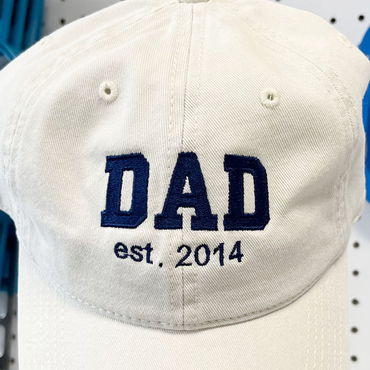 close up of embroidered dad est. date design on a stone baseball cap