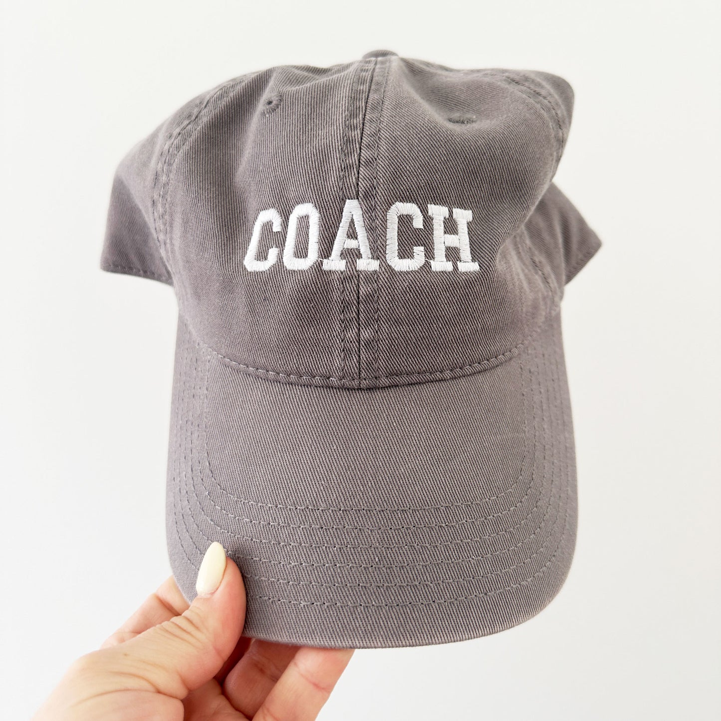 grey hat with custom coach embroidered design