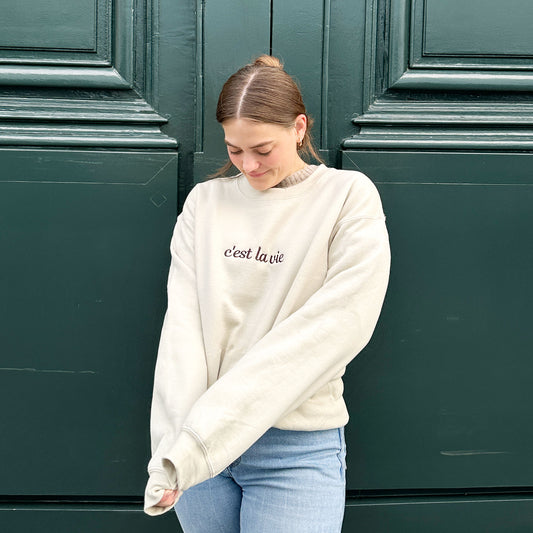 woman wearing c'est la vie script embroidered sand sweatshirt