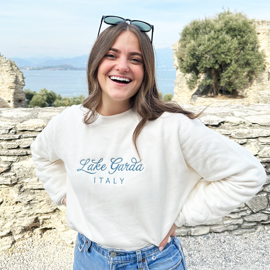 Woman wearing lake garda italy embroidered crewneck sweatshirt in sweat cream with french blue thread