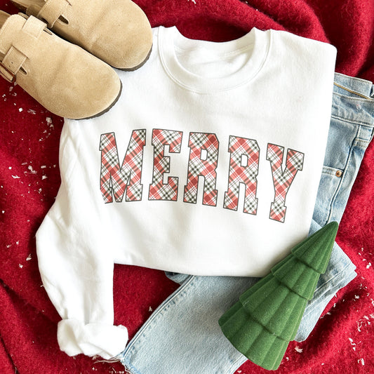 flat lay image of birkinstock clogs, blue jeans, white crewneck sweatshirt with MERRY printed across the chest in a plaid print