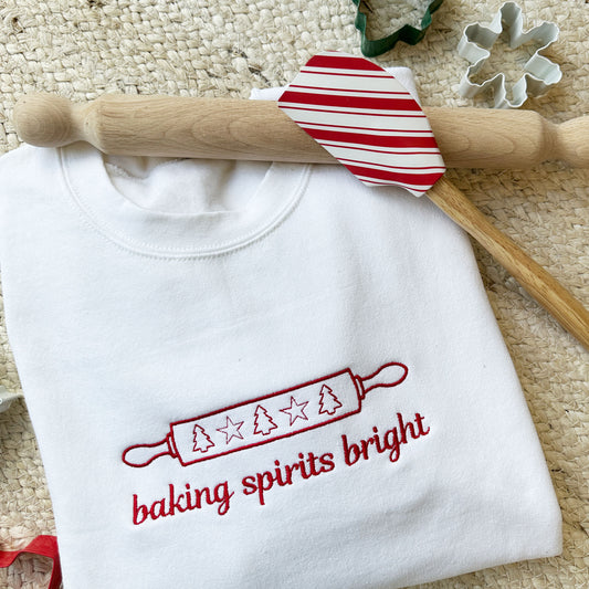 white sweatshirts with baking spirits bright embroidered across the chest surrounded by cookie cutters