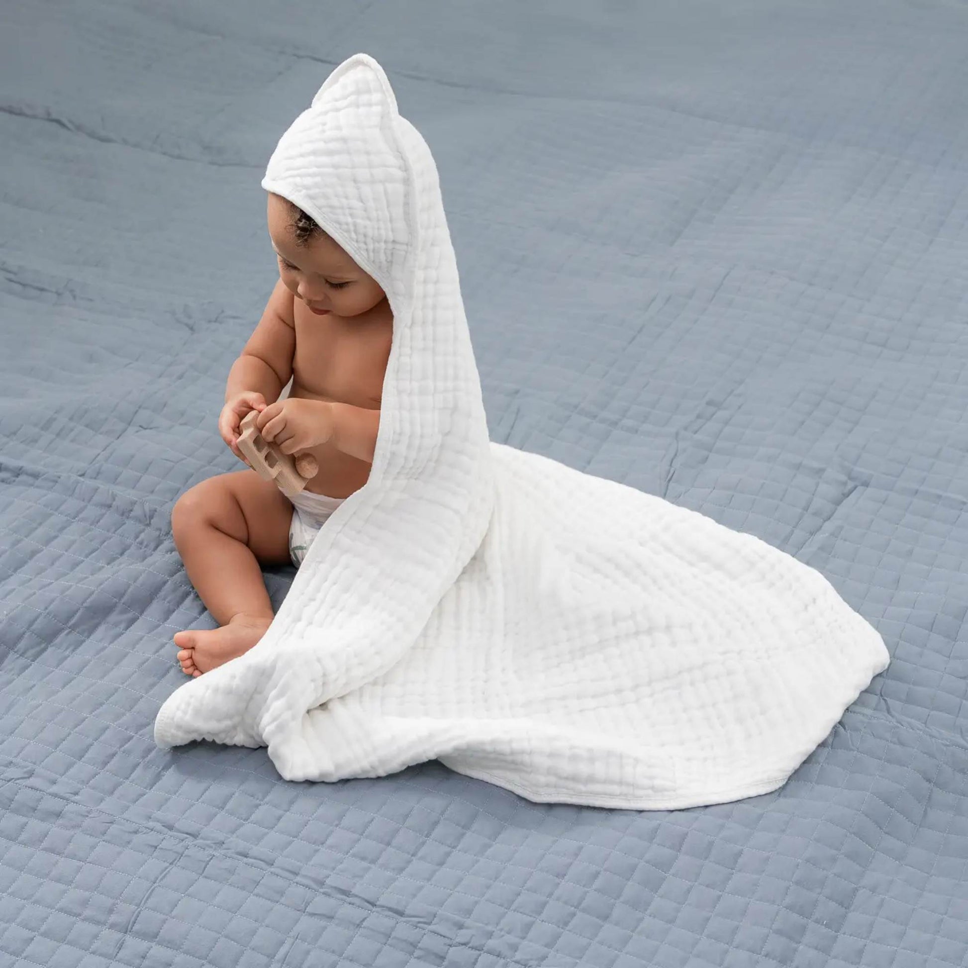 baby wearing a hooded muslin cotton towel