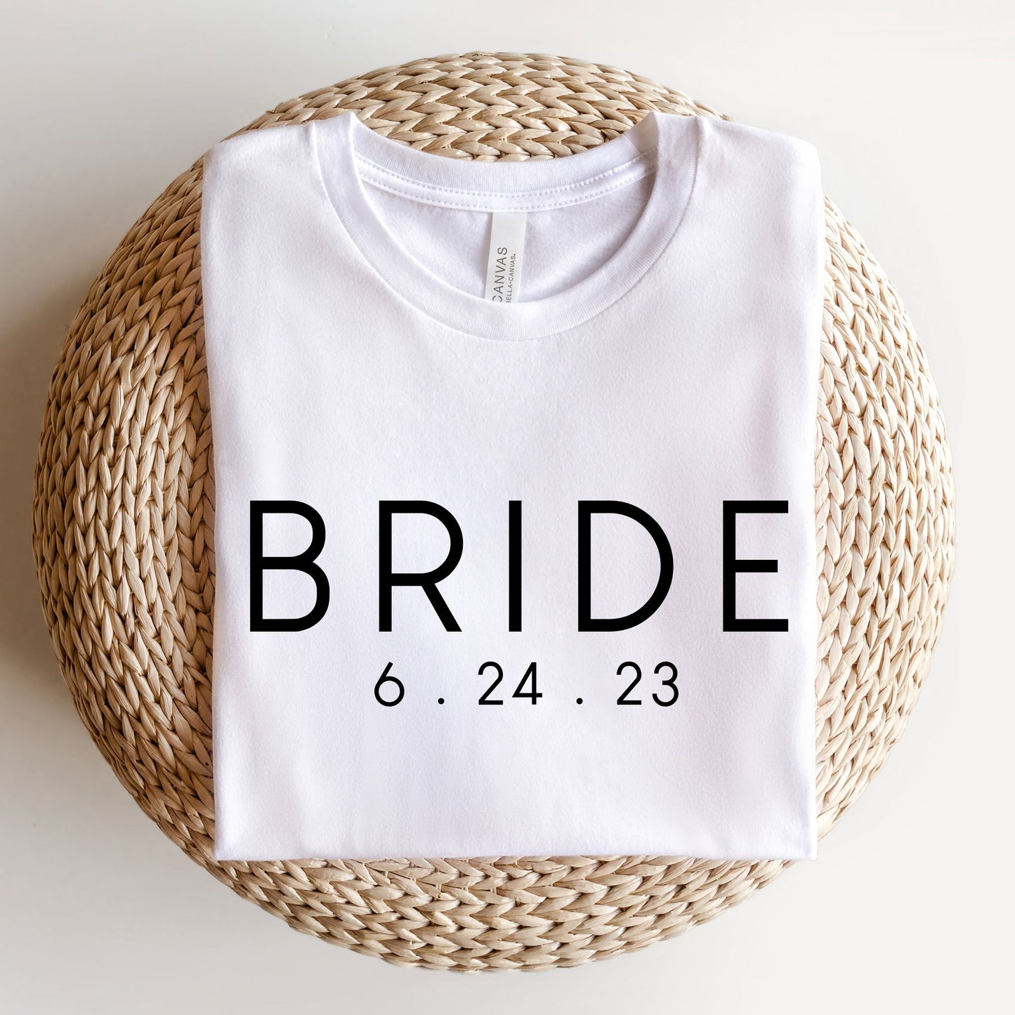 A white bella and canvas t-shirt with a custom BRIDE and wedding date DTG print