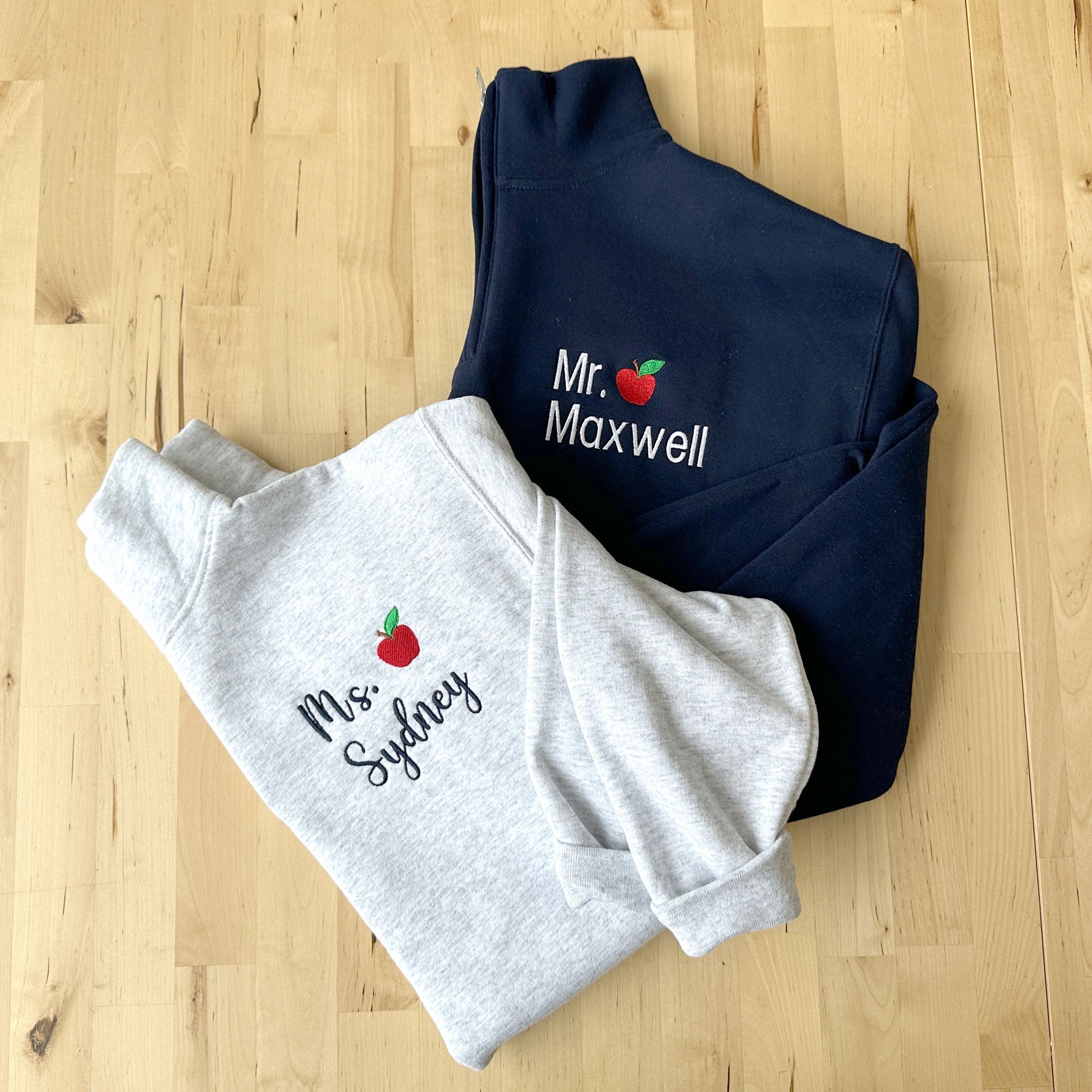 two quarter zip sweatshirts with a personalized name embroidery design on the left chest.
