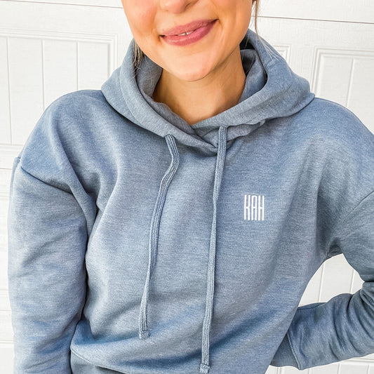 woman smiling wearing heather flint blue cropped sweatshirt