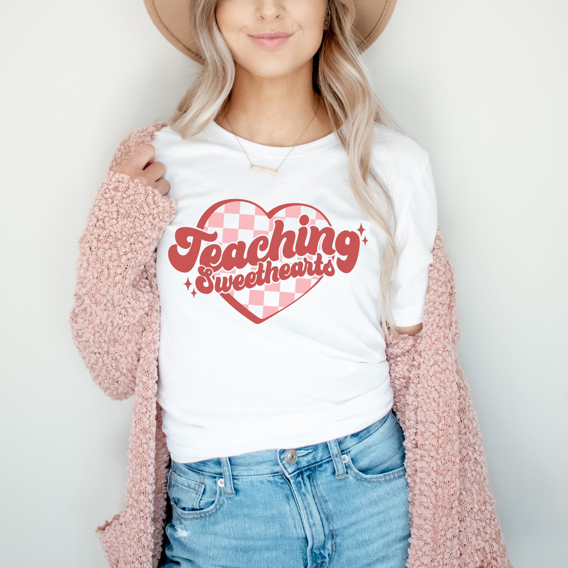 woman wearing a teaching sweethearts printed white in pink and red inktee