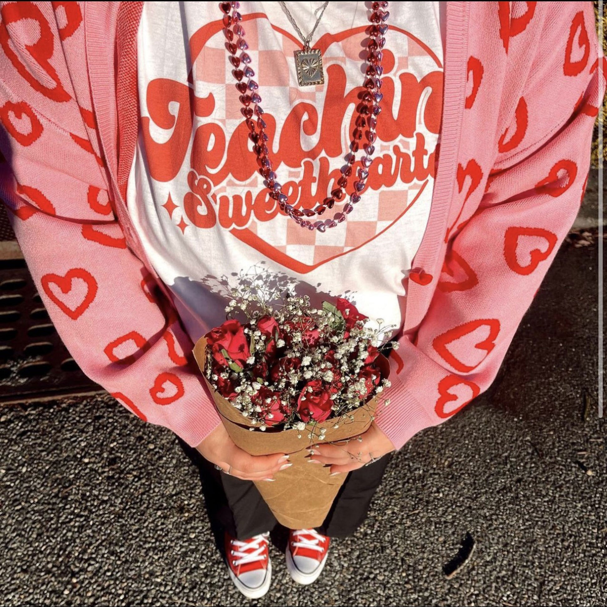 teaching sweatshirts print tee shown on a woman holding flowers