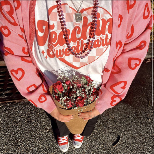 teaching sweatshirts print tee shown on a woman holding flowers