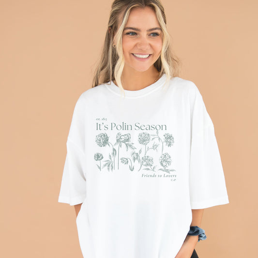 white comfort colors tee with a it's polin season printed design inspired by bridgerton