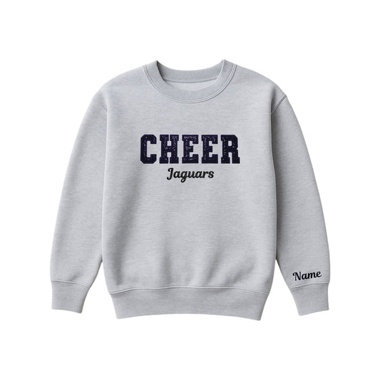 athletic heather boxy crewneck sweatshirt with black glitter applique embroidery reading cheer with jaguars embroidered in a script font underneath, and an optional name embroidery in a script font on the left sleeve 