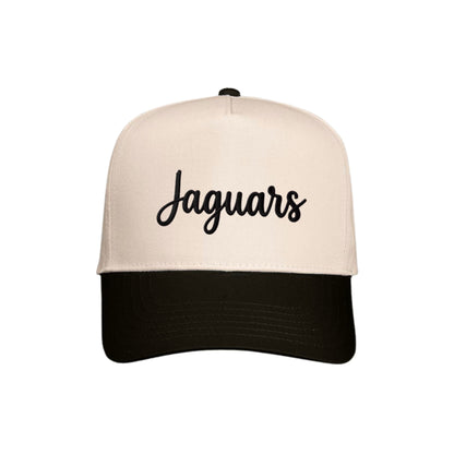 A two-tone baseball cap with an off-white crown and a black curved brim, featuring the word 'Jaguars' embroidered in black script across the front.