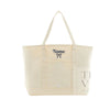An off-white canvas tote bag with two shoulder straps, featuring a navy blue embroidered 'Name' and bow on the front pocket, and a translucent side pocket with a gray graphic.