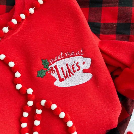 red crewneck sweatshirt with custom embroidered "meet me at Luke's" coffee cup holly design on the left chest