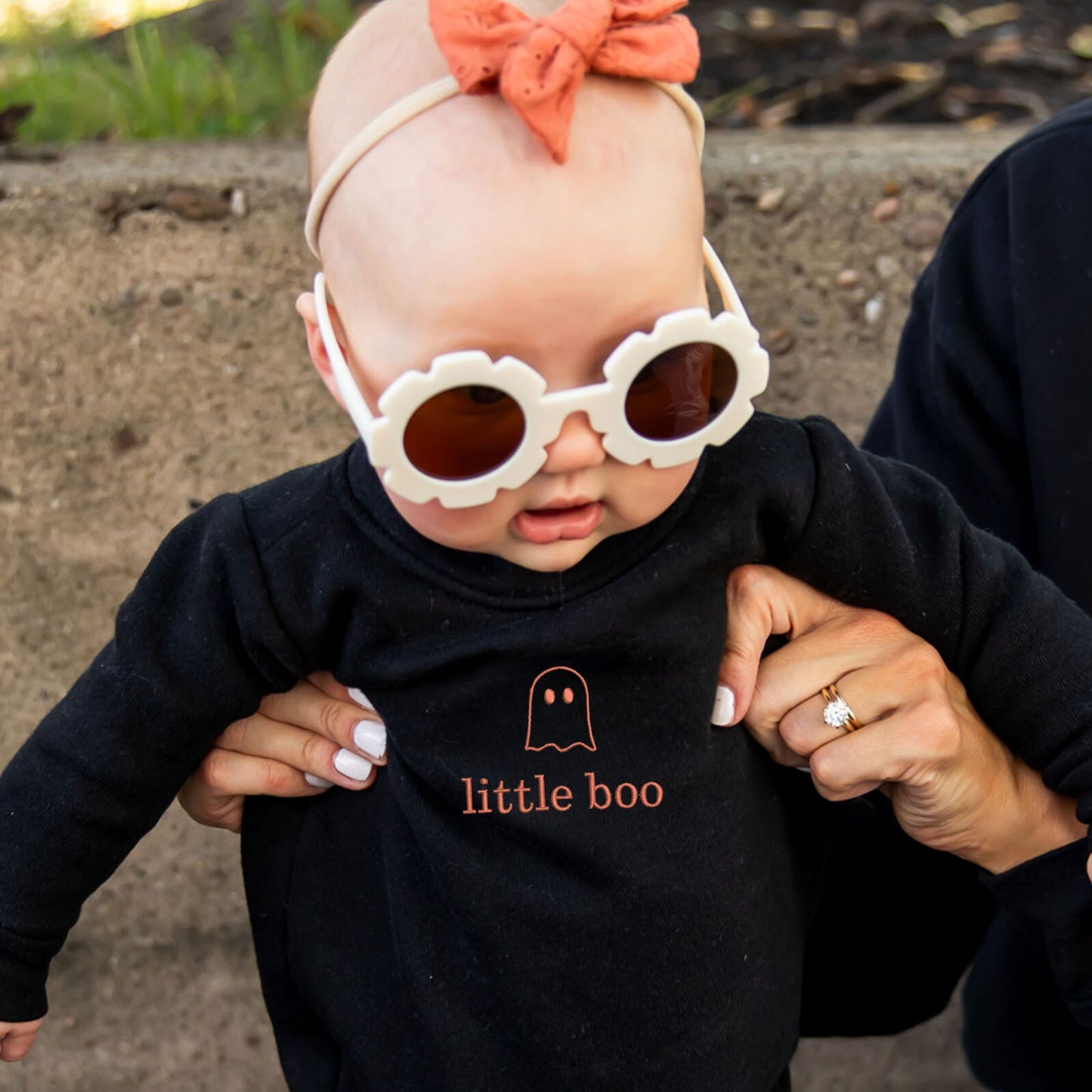 baby girl wearing a black long sleeve bodysuit with a cute ghost little boo embroidered design