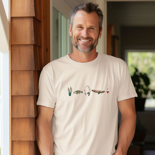 Man wearing an ivory t-shirt with custom embroidered fishing icons including cattails, bass fish, fishing rod, canoe, and bobbin across the chest