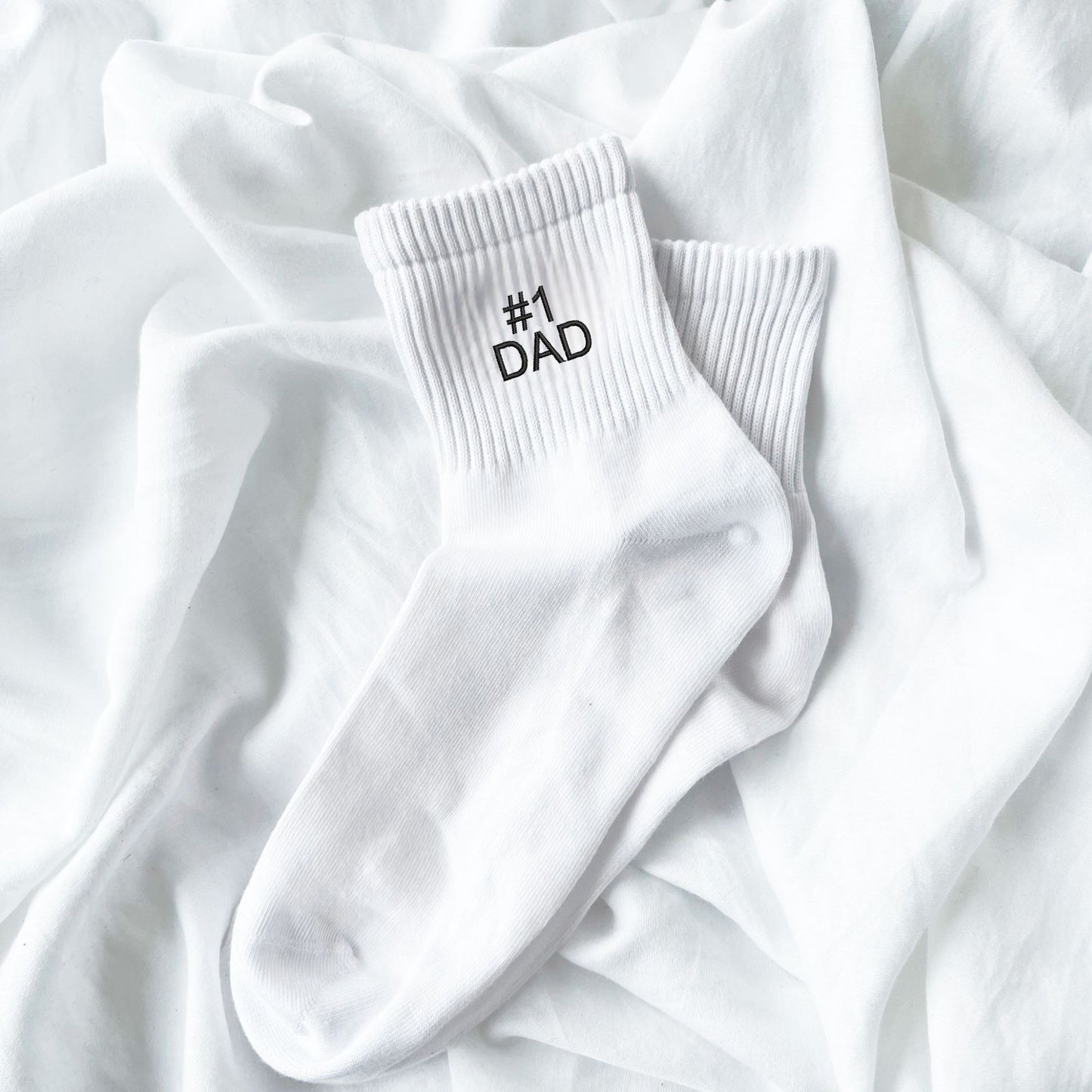 white crew socks with custom #1 dad embroidery in black thread
