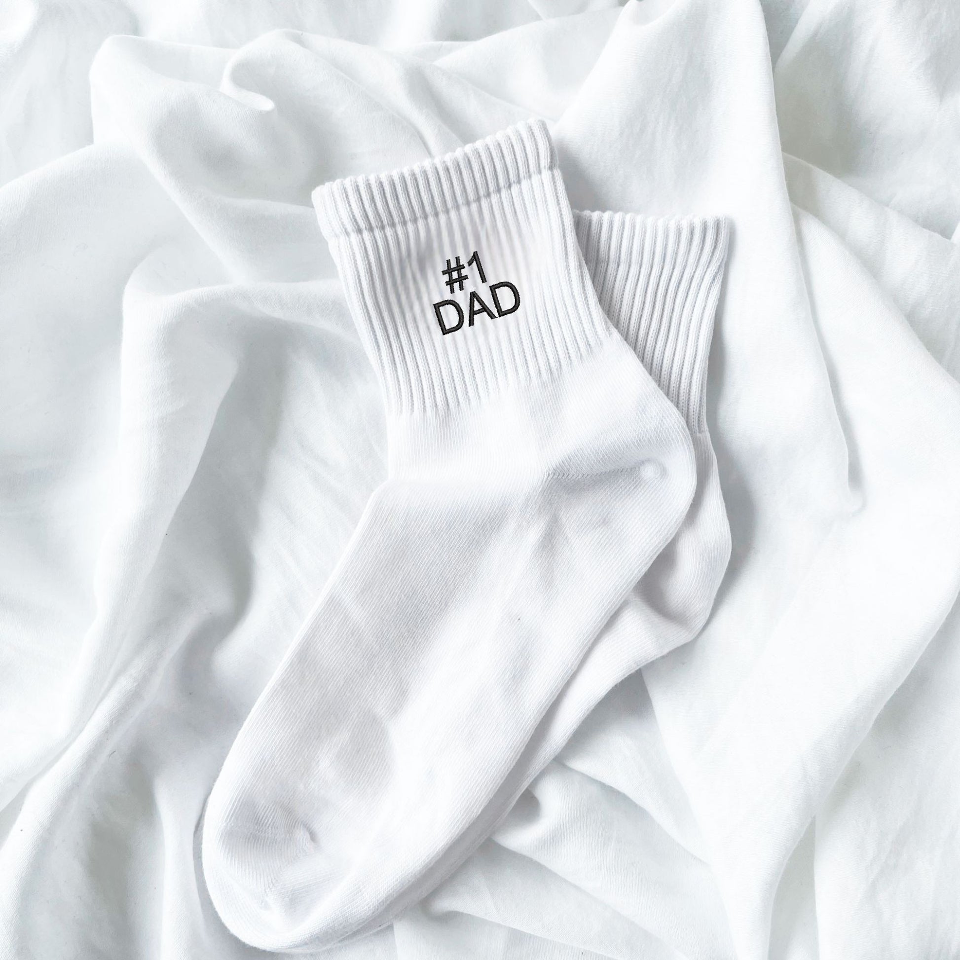 white crew socks with custom #1 dad embroidery in black thread