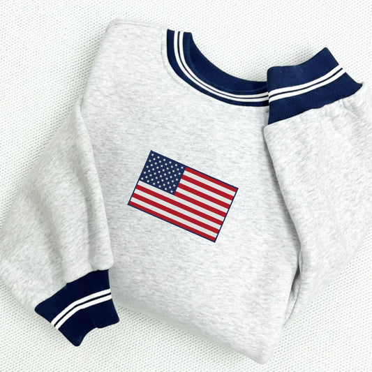 White sweatshirt with American flag embroidery on a white background