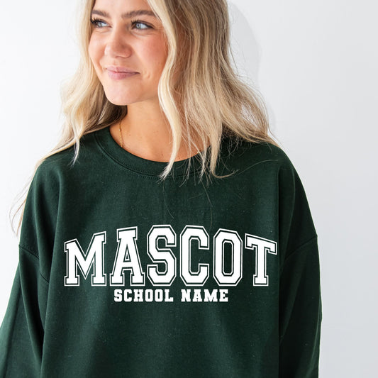 woman wearing an oversized forest green sweatshirt with a large custom mascot school name printed design