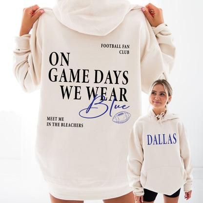 White hoodie with text 'On game days we wear blue, meet me in the bleachers' and 'Dallas' on a white background.