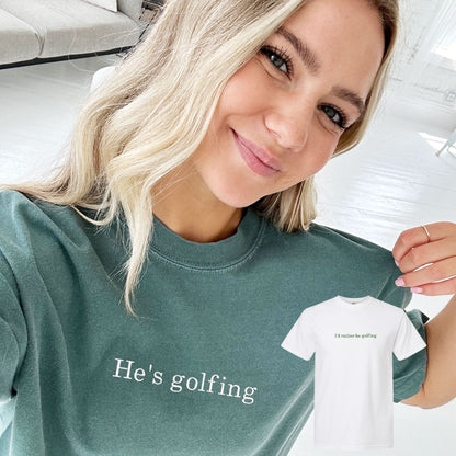 woman wearing a light green comfort colors t-shirt with custom he's golfing embroidered design in white thread cross the chest and a matching white tee with I'd rather be golfing embroidered in hunter green thread across the chest
