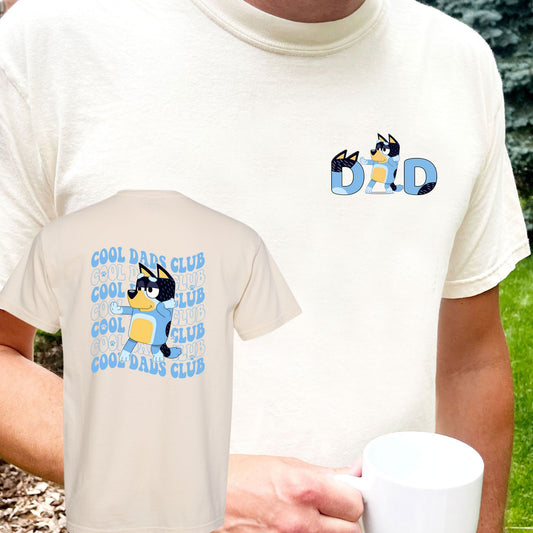 dad wearing an ivory comfort colors t-shirt with a bluey dad print on the front chest and the back has a large cool dads club bluey print