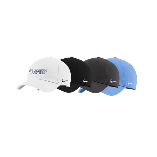 Four Nike caps in white, black, and blue on a white background