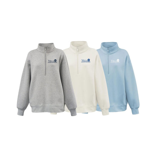 Three quarter-zip sweatshirts shown on a plain white background: heather gray, off-white, and light blue. Each sweatshirt has a small chest logo reading villa.