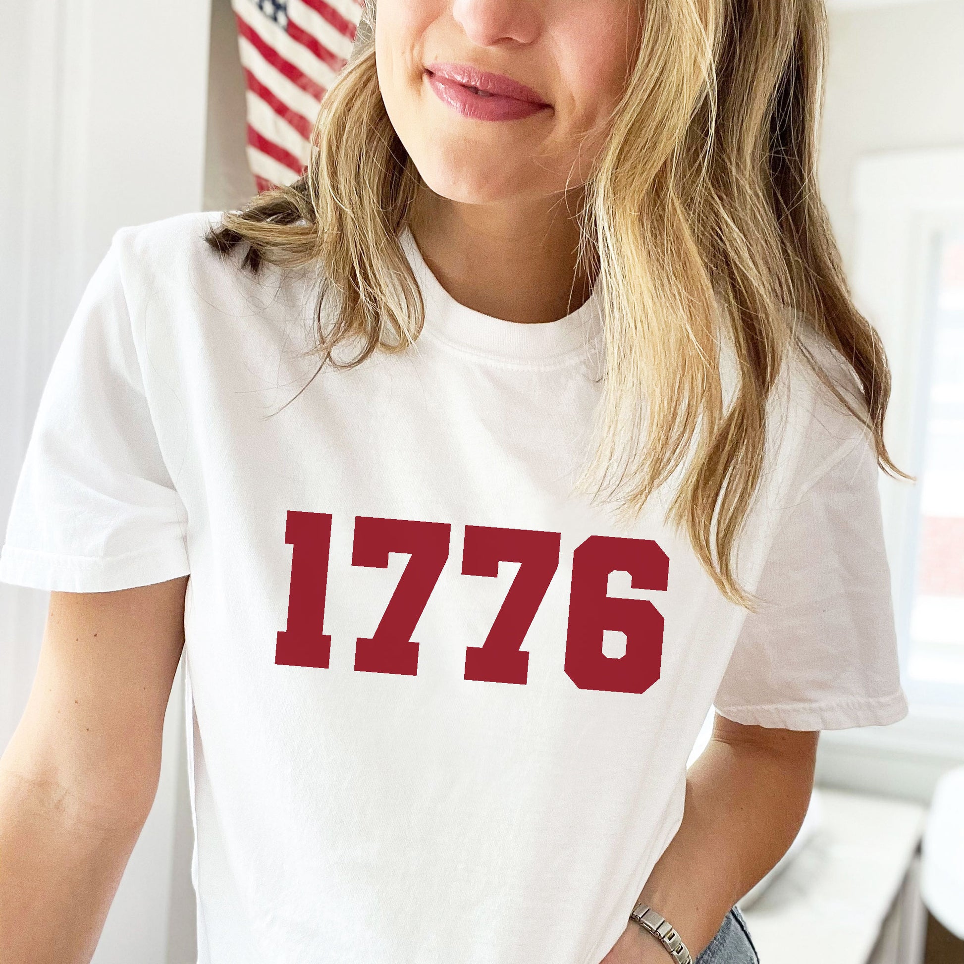 woman wearing a white tee with a 1776 print