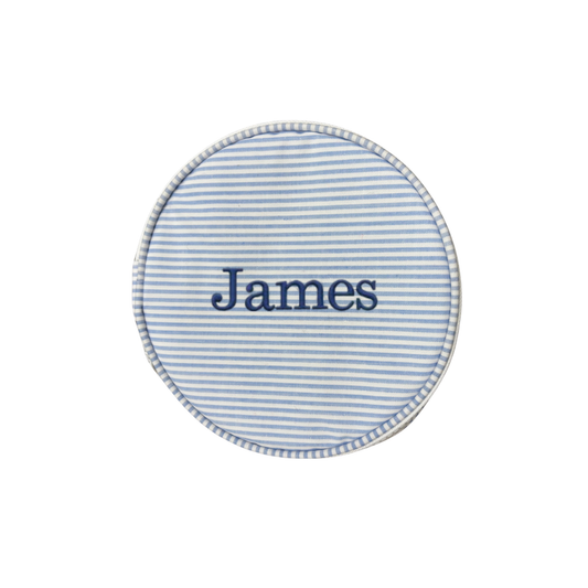Round blue and white striped fabric patch with 'James' embroidered on a white background