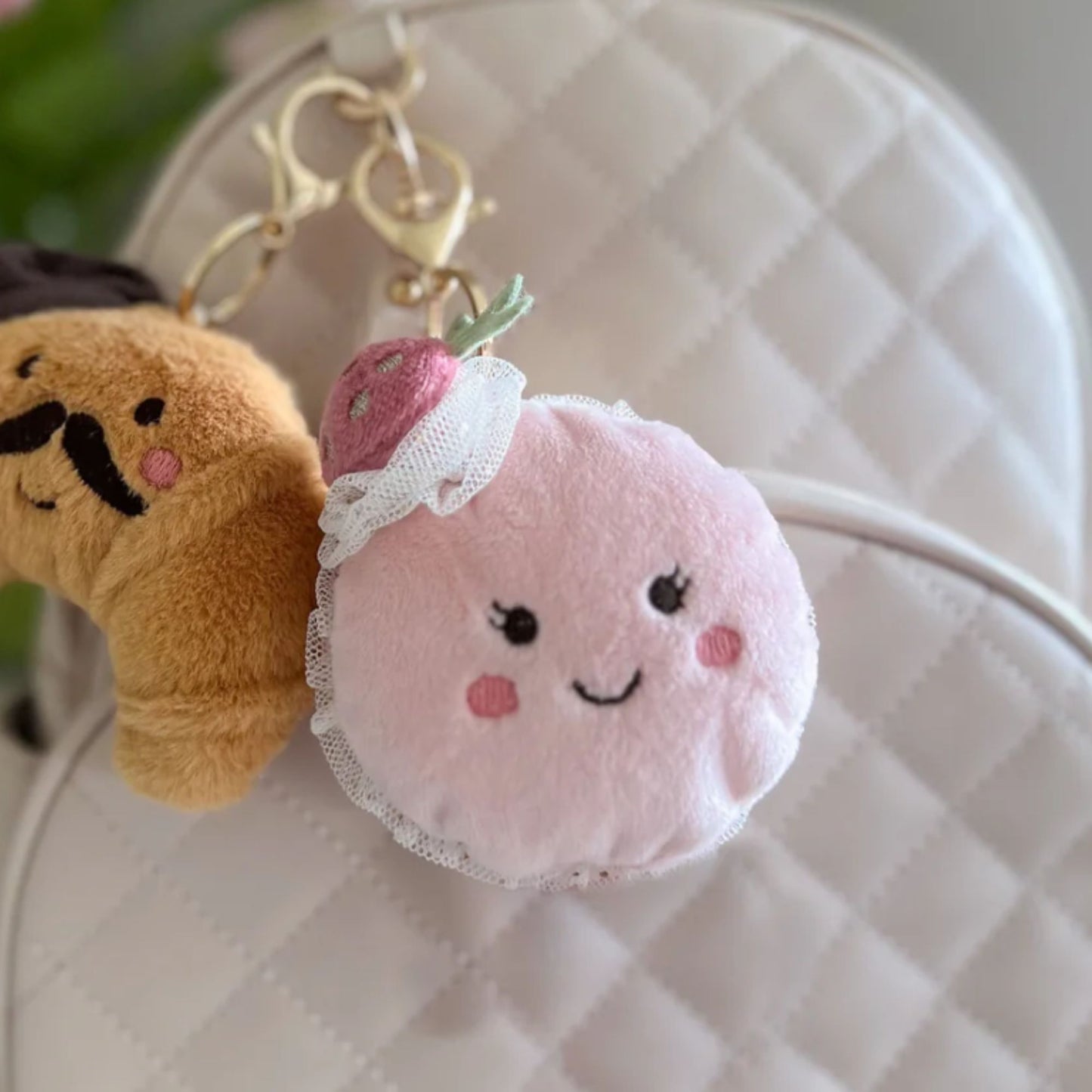 stuffed bag charms hanging on backpack