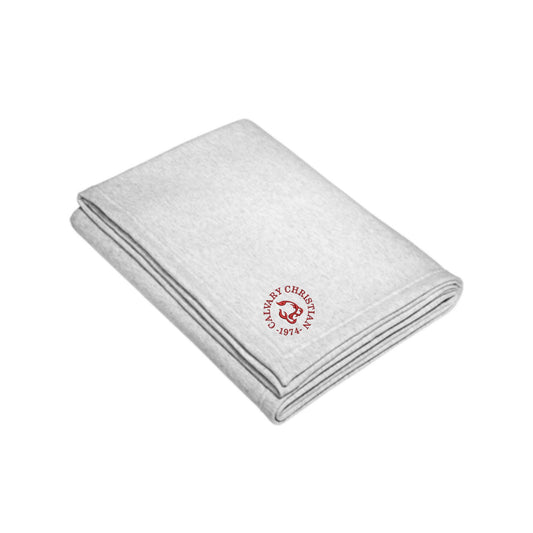 folded ash sweatshirt blanket with a round calvary christian 1975 cougar logo embroidered in red thread on the corner