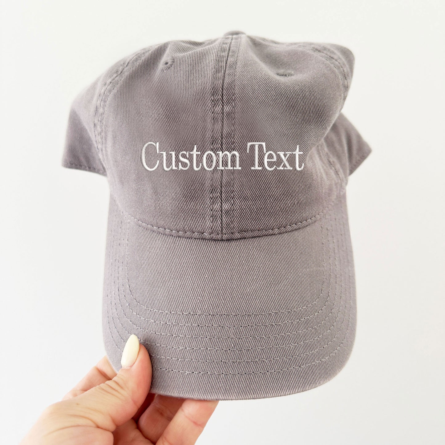 grey hat with custom embroidered text in  white thread