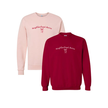 Pink and red sweatshirts with 'Neighborhood Barre' text on a white background