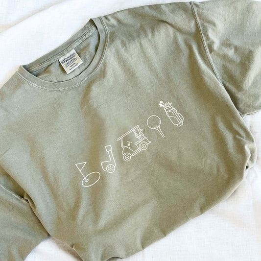 bay comfort colors t-shirt with custom outlined golf icon printed design featuring: golf bag, golf ball on a tee, golf cart, golf club, and golf green/flag