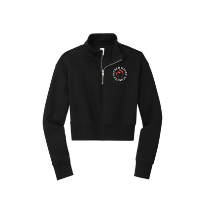 black cropped quarter zip with custom printed sacred heart schools heart logo on the left chest in white and red ink